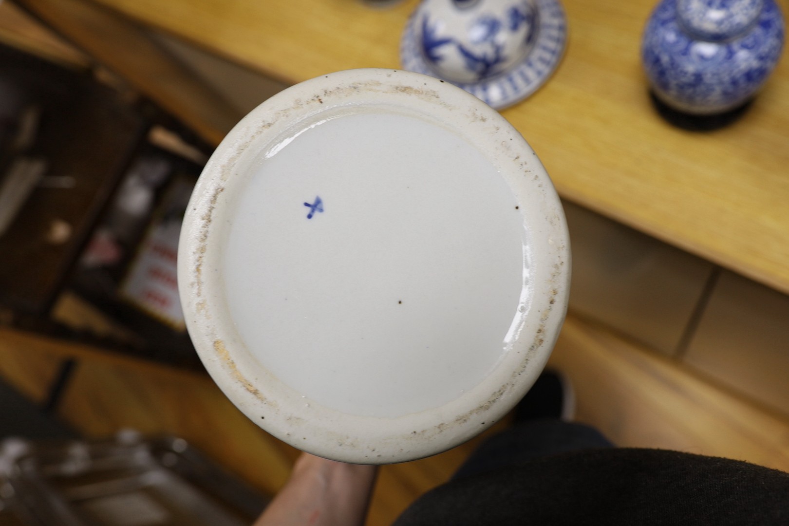 A pair of Japanese black ground vases, a pair of Chinese blue and white vases and covers, a similar pair of jars and a vase, four wood stands. Largest 41cm